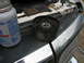 1995 Ford C-350 (Centurion Conversions) - A pulley and a bottle of lubricant are shown on the vehicle's engine bay, with part of the headlight visible.