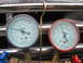 1995 Ford C-350 (Centurion Conversions) - Robinair AC manifold gauges are shown attached to a vehicle's chrome grille.