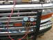 1995 Ford C-350 (Centurion Conversions) - AC manifold gauge set connected to the front of a 1995 Ford truck, likely for servicing the air conditioning system.