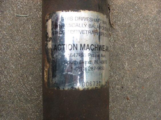 Driveshaft with a label from Action Machine, Inc. showing address and phone number