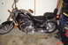 2002 Suzuki VL 1500 Intruder Classic - A black cruiser motorcycle is parked in a garage with tools and storage bins nearby.