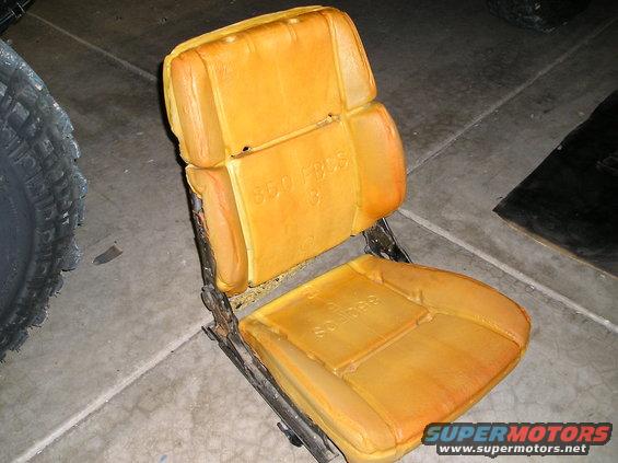 Orange car seat foam with visible text '800 FBOS' and 'Soulbag' on a metal frame