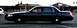 2001 Ford Crown Victoria - A dark-colored 2001 Ford Crown Victoria police car is seen from the side in a parking lot.