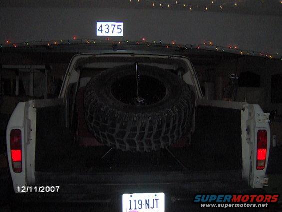 White 1979 Ford Bronco rear view with spare tire mounted in bed, license plate 119-NJT