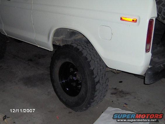White SUV rear quarter panel, tire, and taillight. Appears to be a 1978 model