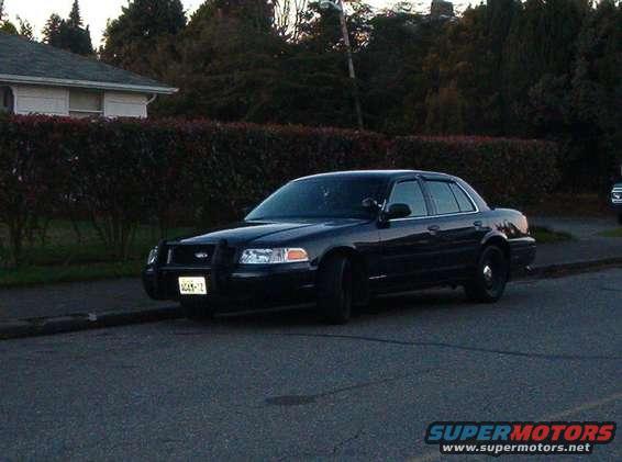 Black 2001 Ford Crown Victoria parked on a street, front-left view
