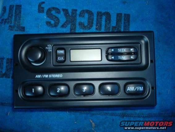 Car radio with AM/FM stereo, seek, tune, tone, and clock buttons. Has preset buttons 1 through 4