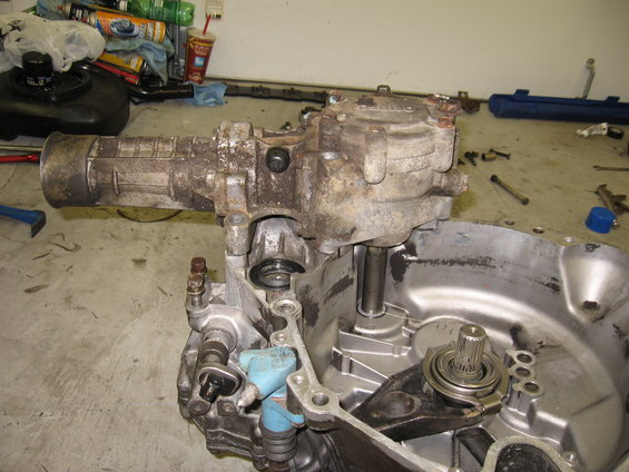 Disassembled car transmission with transfer case and gears visible