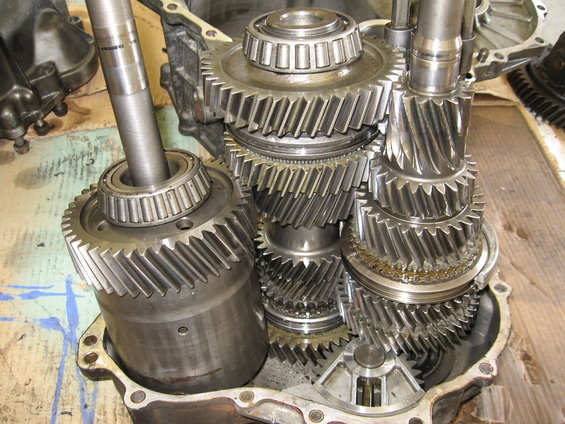 Close-up of disassembled transmission gears and shafts inside a housing