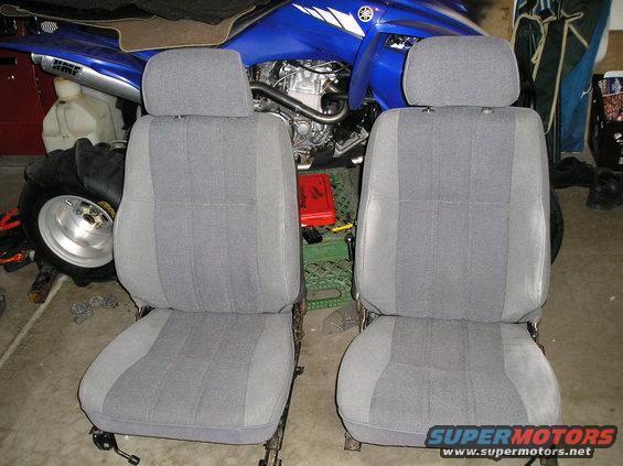 Two grey fabric car seats with headrests