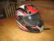 2004 Yamaha RAPTOR 660 - A motorcycle helmet with a graphic design sits on a wooden surface.