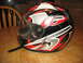 2004 Yamaha RAPTOR 660 - A colorful motorcycle helmet sits on a wooden surface, with a chair visible in the background.