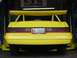 1986 Mercury Cougar - Yellow 1986 Mercury Cougar LS with a prominent rear spoiler and custom license plate '86 COOGR'.