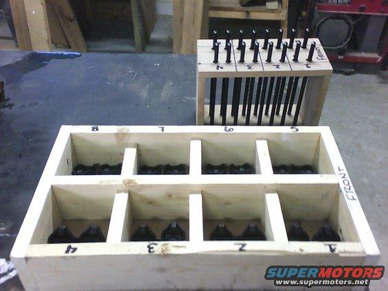 Engine parts organized in numbered wooden crates