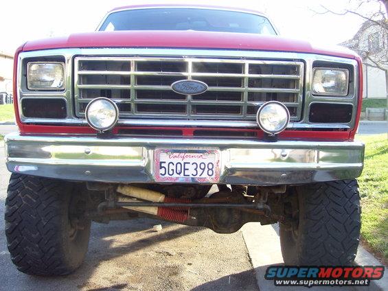 Red 1986 Ford Bronco front view with chrome grille and California license plate 5GOE398