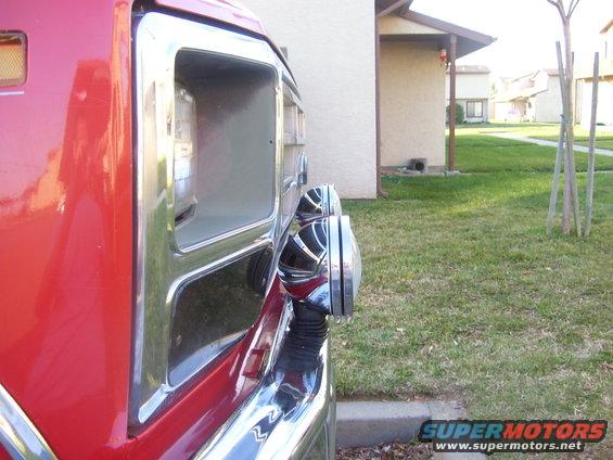1986 Ford Bronco side view showing fender, chrome trim, and dual headlights