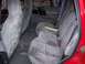 1994 Jeep Grand Cherokee - The interior of a red Jeep Grand Cherokee shows grey velour seats and a book on the rear bench.
