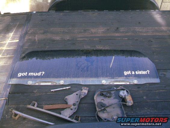 Rear window with "got mud?" and "got a sister?" decals