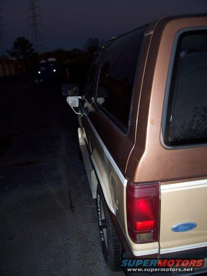 Brown 1984 Ford Bronco II rear quarter panel with a Ford emblem and a two-tone paint scheme