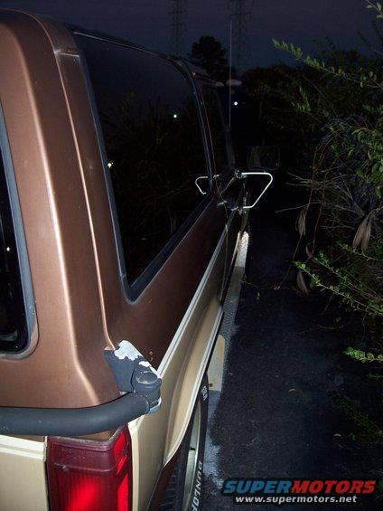 Brown SUV side view, dark exterior with chrome trim and tinted windows