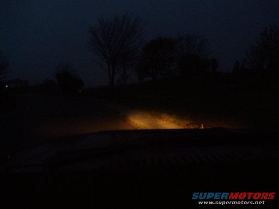Headlights on a dark road at night