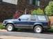 1991 Ford Explorer - This two-door SUV is parked next to a building with wood siding.