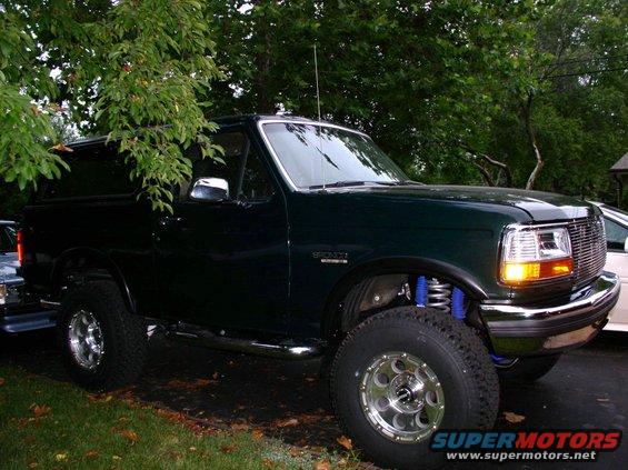 1993 Ford Bronco parked outside with trees in the background