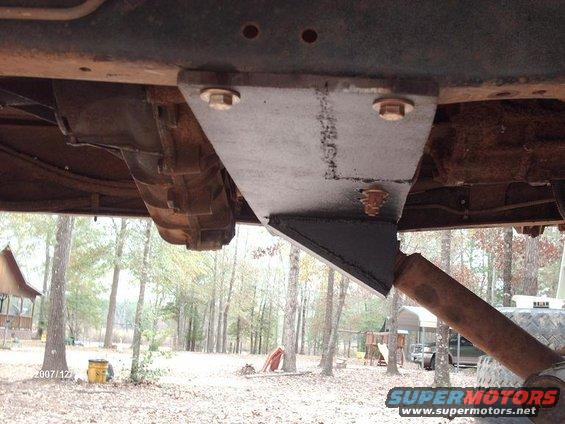 Custom suspension bracket attached to truck frame near transmission