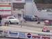 1999 Ford Crown Victoria - A white sedan is positioned at the starting line of a drag strip, with other vehicles and track infrastructure visible in the background.