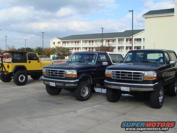 Black 1992 Ford Bronco parked in a lot, front 3/4 view, lifted suspension