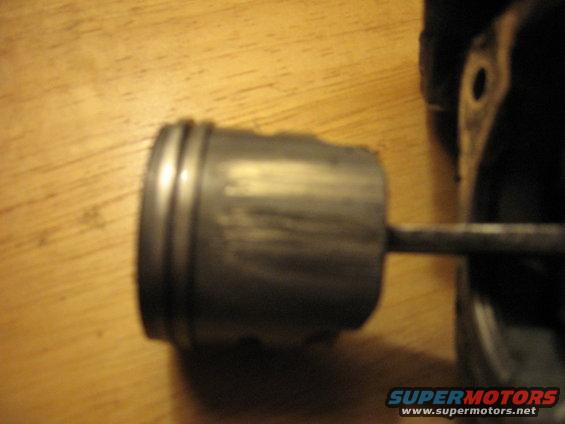Close-up of a piston on a wooden surface