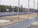 1999 Ford Crown Victoria - A drag strip scene with scoreboards displaying times and a few vehicles visible in the distance.