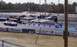 1999 Ford Crown Victoria - A silver sports car is positioned on the drag strip, with other vehicles and spectators visible in the background.