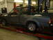 1994 Ford F-250 - Side view of a gray pickup truck in a repair bay. The tires are marked 'Tiger Paw GTS'.