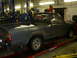 1994 Ford F-250 - Side view of a gray Toyota pickup truck in a garage, showing rust and snow in the bed.