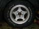 1994 Ford F-250 - A close-up view of a vehicle's tire and wheel assembly, showing brand names on the tire.