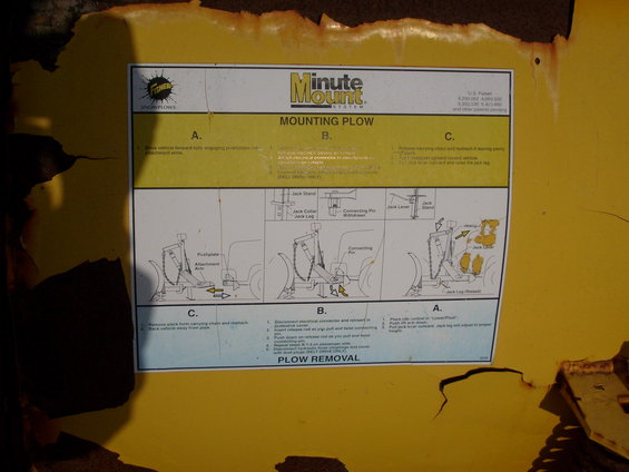 Instructional sticker for mounting a plow on a yellow surface