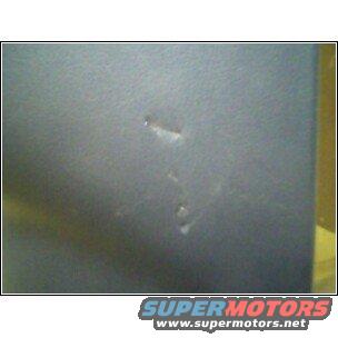 Close-up of paint chip on a gray car door