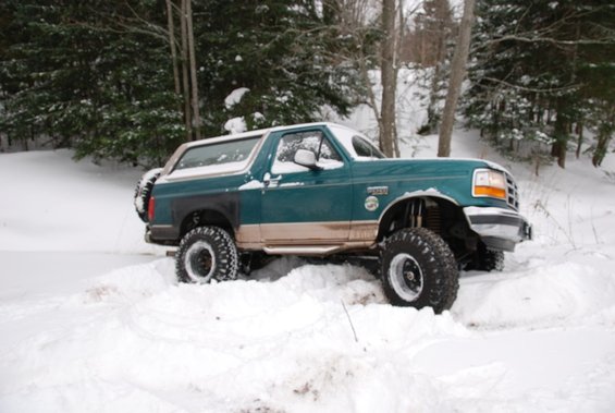 1996 Ford Bronco with lifted suspension stuck in snow, side view