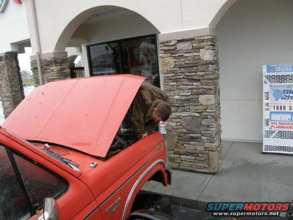 Red 1986 Ford Bronco with hood open, driver side view