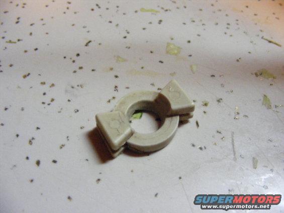 Beige plastic part with two triangular protrusions