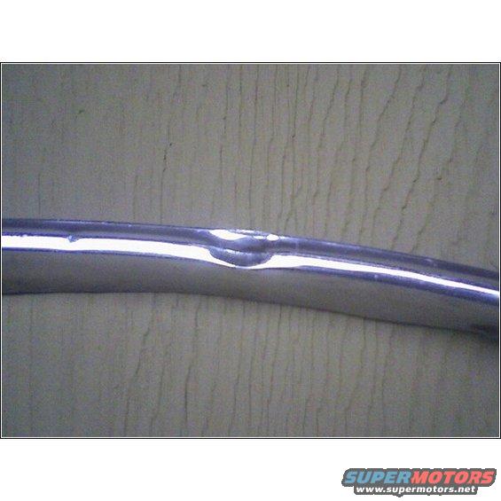 Chrome trim piece with a noticeable dent
