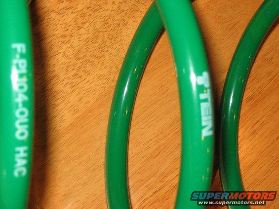 Green suspension springs with white text 'F-P104-QUO HAC' and 'STEIN'