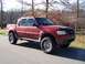 2002 Ford Sport Trac - This red 2002 Ford Sport Trac features a lifted suspension and off-road tires, ready for adventure.