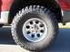 2002 Ford Sport Trac - Close-up of a tire and wheel on a red vehicle. The album claims it is a 2002 Ford Sport Trac.