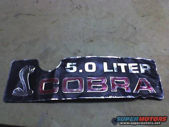 Black 5.0 Liter Cobra emblem with a coiled snake logo and red lettering