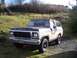 1978 Ford Bronco - This 1978 Ford Bronco is seen from a 3/4 front angle, parked on a gravel driveway with a grassy hill in the background. The license plate i…