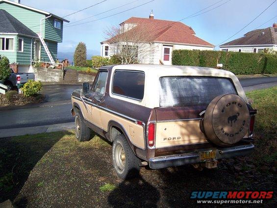 1978 Ford Bronco parked on a residential street, rear view. Spare tire cover has Bronco logo