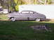 1950 Mercury Sedan - A gray 1950 Mercury Sedan is parked on a grassy lawn next to a white building.