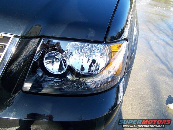 Black SUV headlight and grille detail